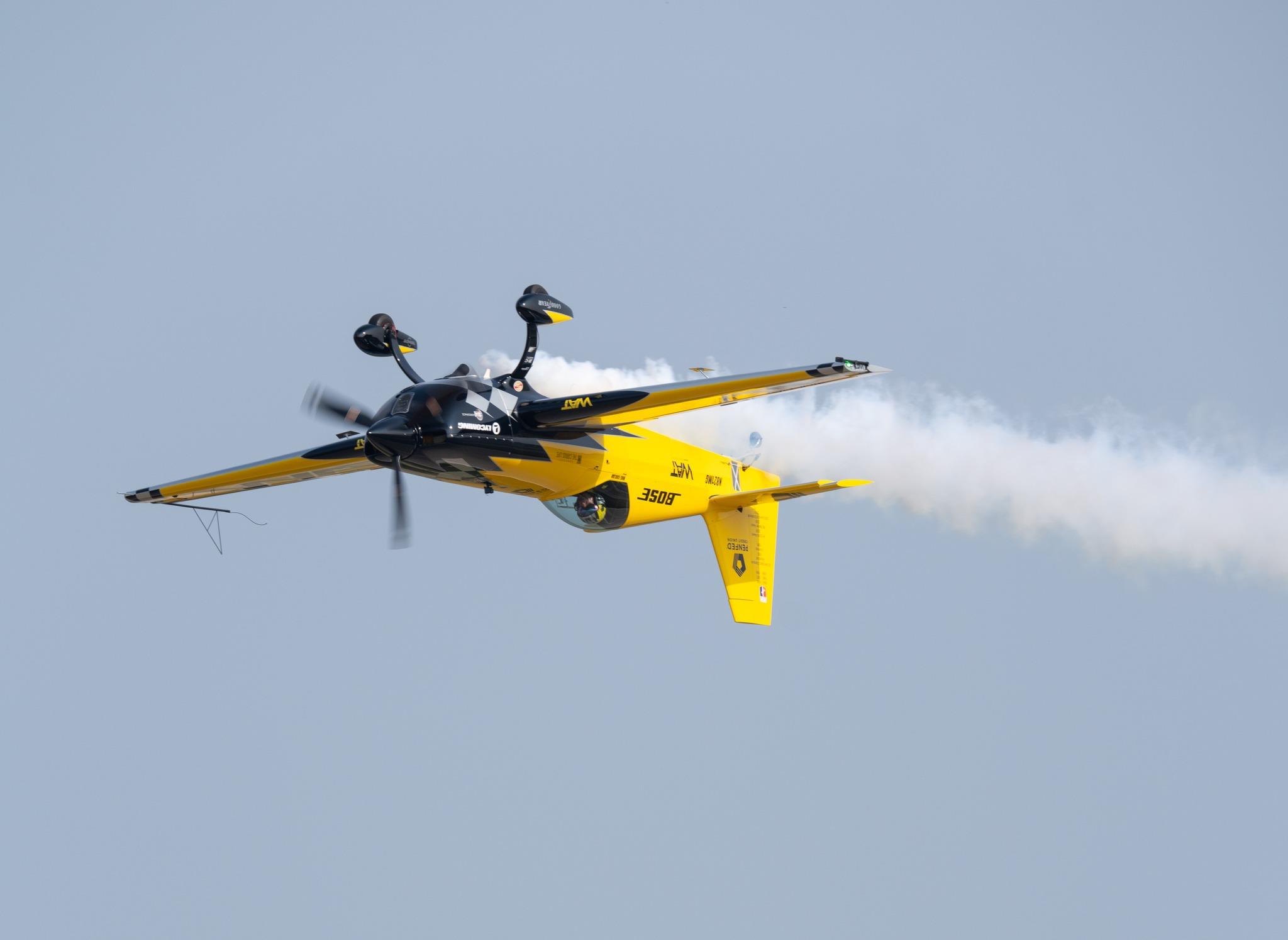 Mike Goulian inside a yellow airplane in the sky