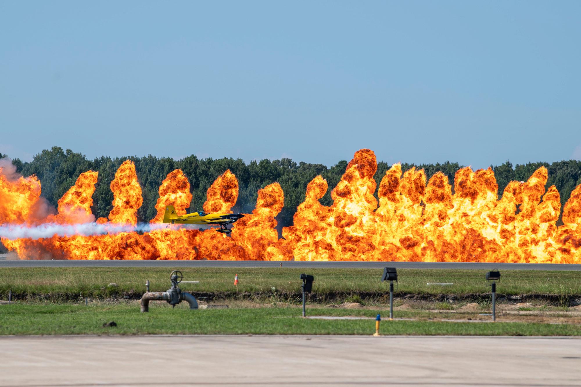 pilot michael goulian flying in front of a wall of fire