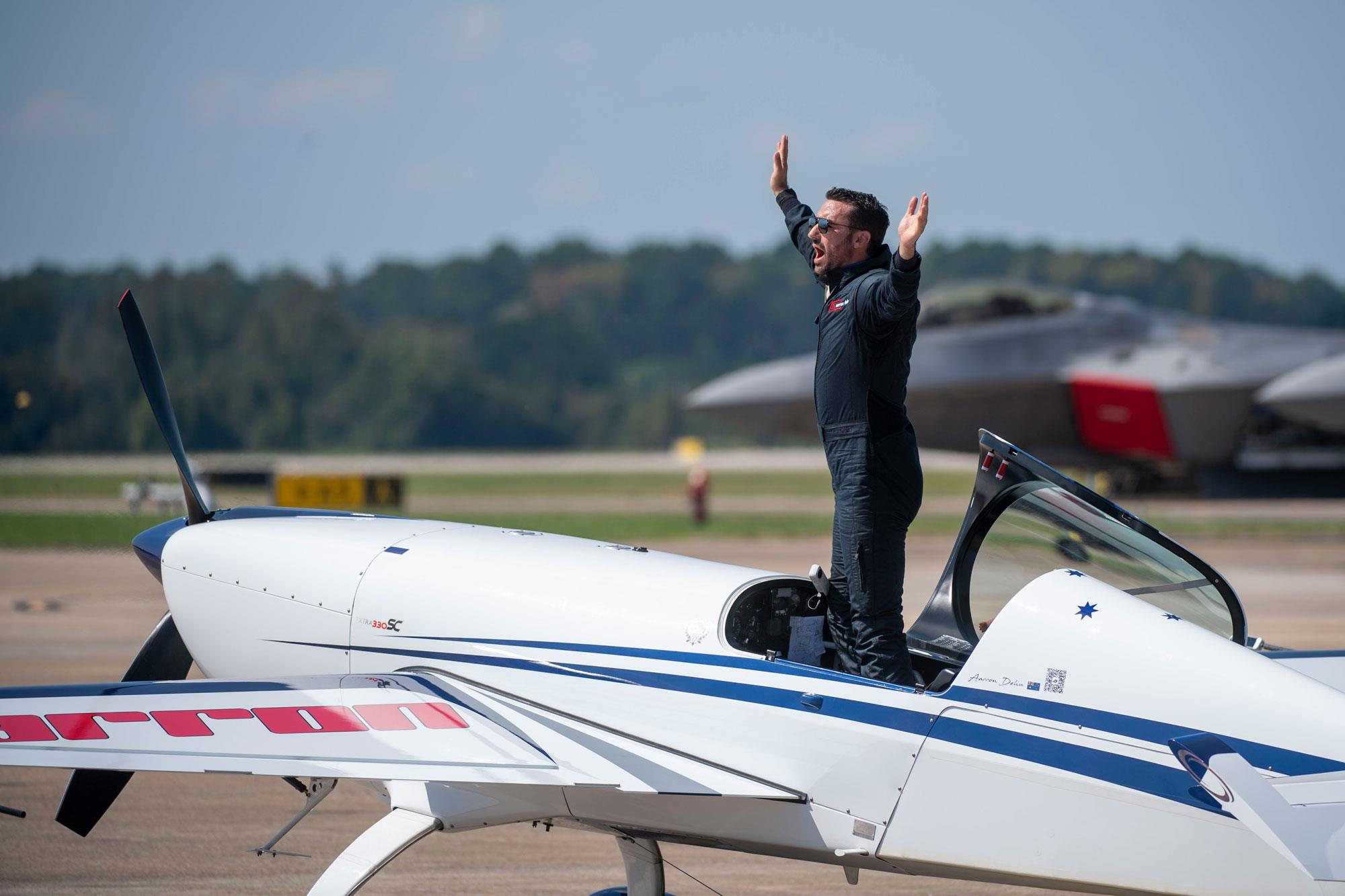 Pilot Aaron Deliu standing in his plane